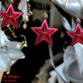 Go Hooked red star ornaments with glitter accents, perfect for festive home decor and Christmas trees.