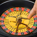 Go Hooked roulette drinking game set with gold wheel, black and red numbered slots, and metal spinner. Includes 16 shot glasses.