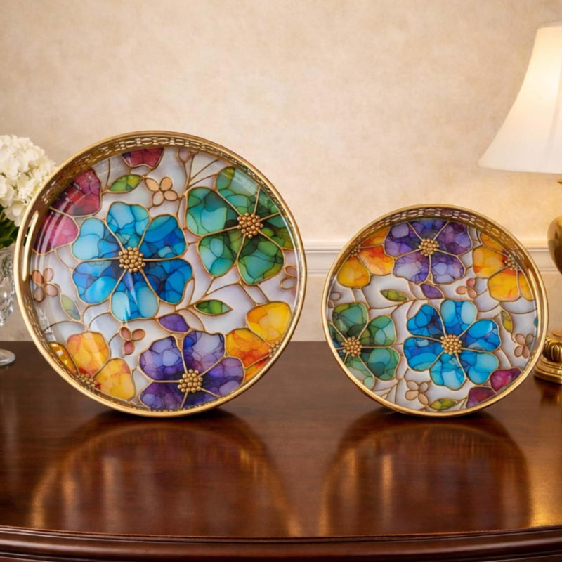 Go Hooked set of 2 round metal decorative trays with colorful floral stained glass art and gold trim.