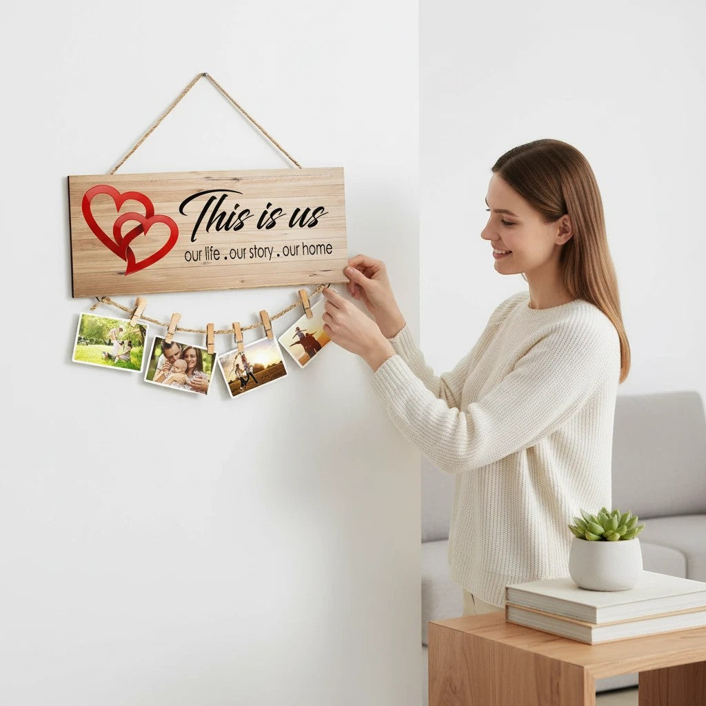 GoHooked brown MDF wood sign with "This is us, our life, our story, our home" and red hearts, holding photos with clips.