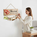 GoHooked brown MDF wood sign with "This is us, our life, our story, our home" and red hearts, holding photos with clips.