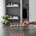 GoHooked handcrafted matte gold iron tealight candle holder with 5 trays and scroll design.