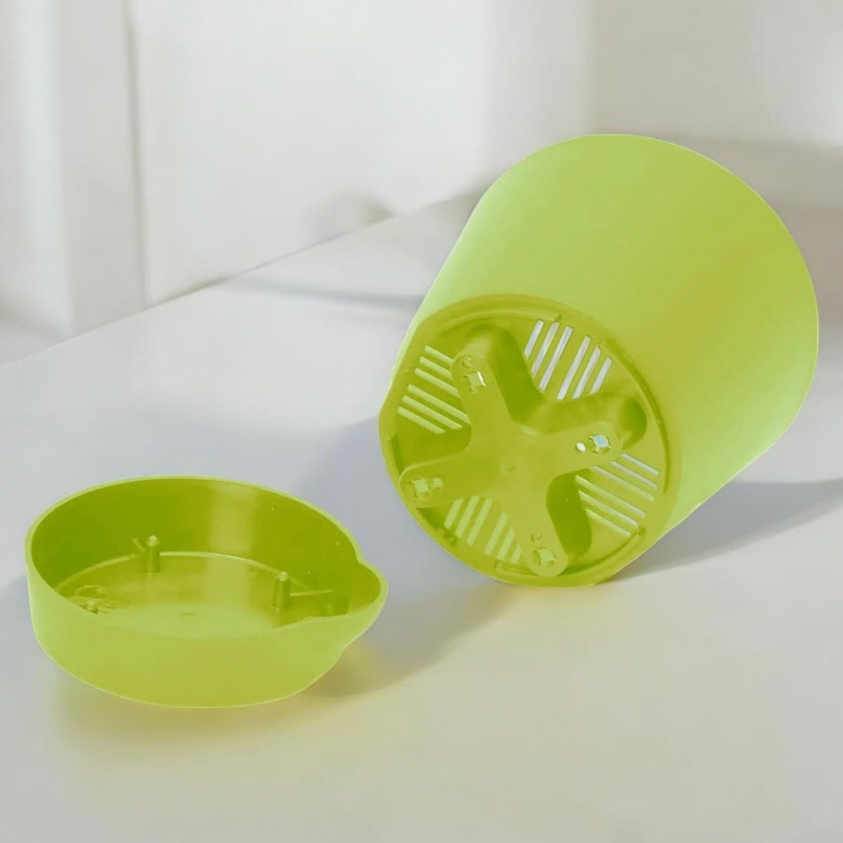 GoHooked 4-inch light green plastic self-watering planter pot with drainage and water reservoir.