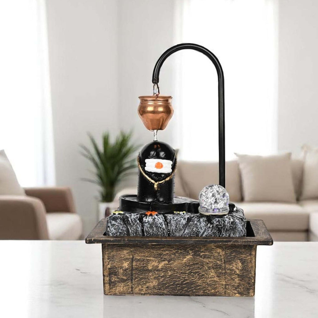 GoHooked polyresin Shiva lingam tabletop fountain with copper pot, LED light, and textured rock base.
