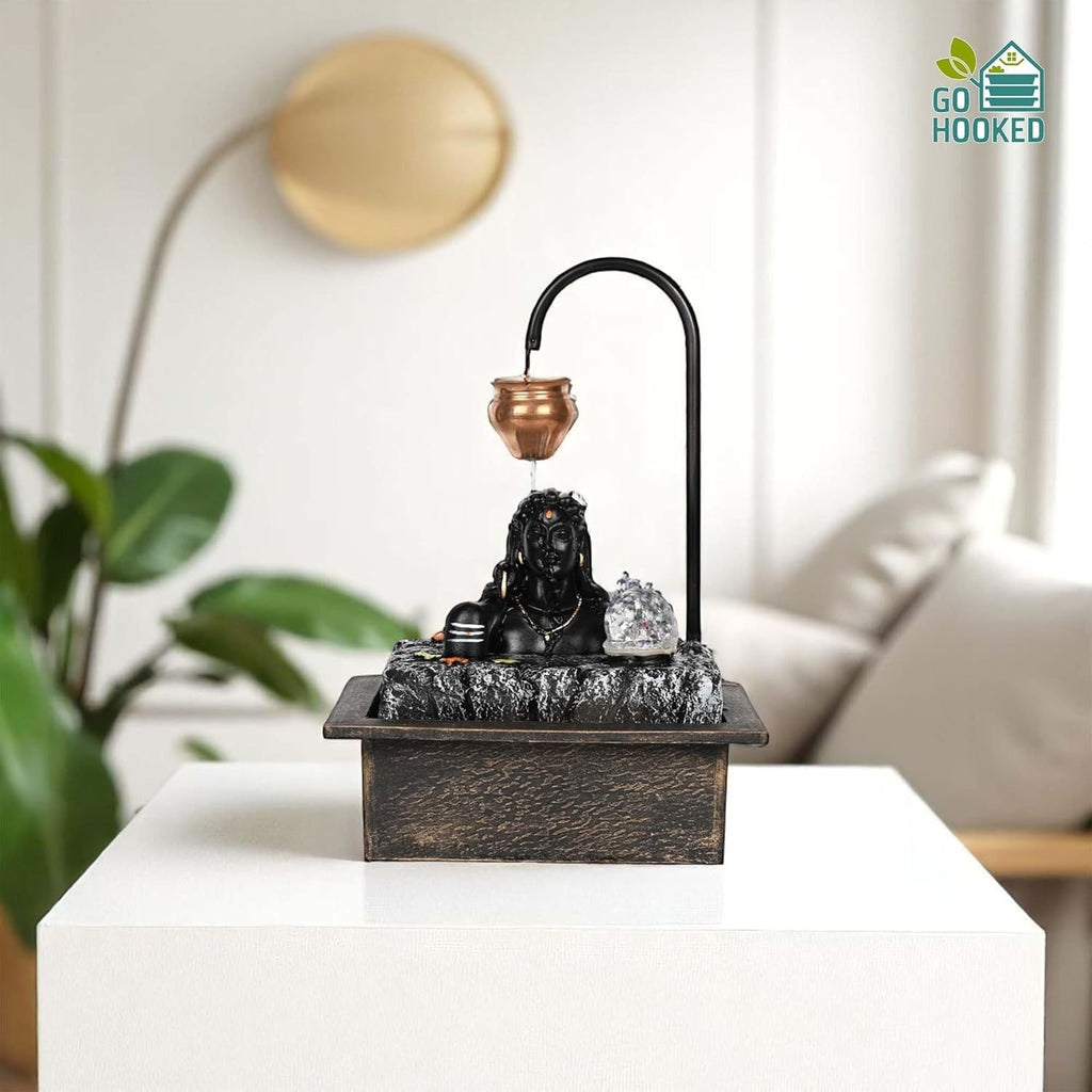 Go Hooked Lord Shiva tabletop water fountain with LED crystal ball and copper kalash drip. Matte black polyresin waterfall.
