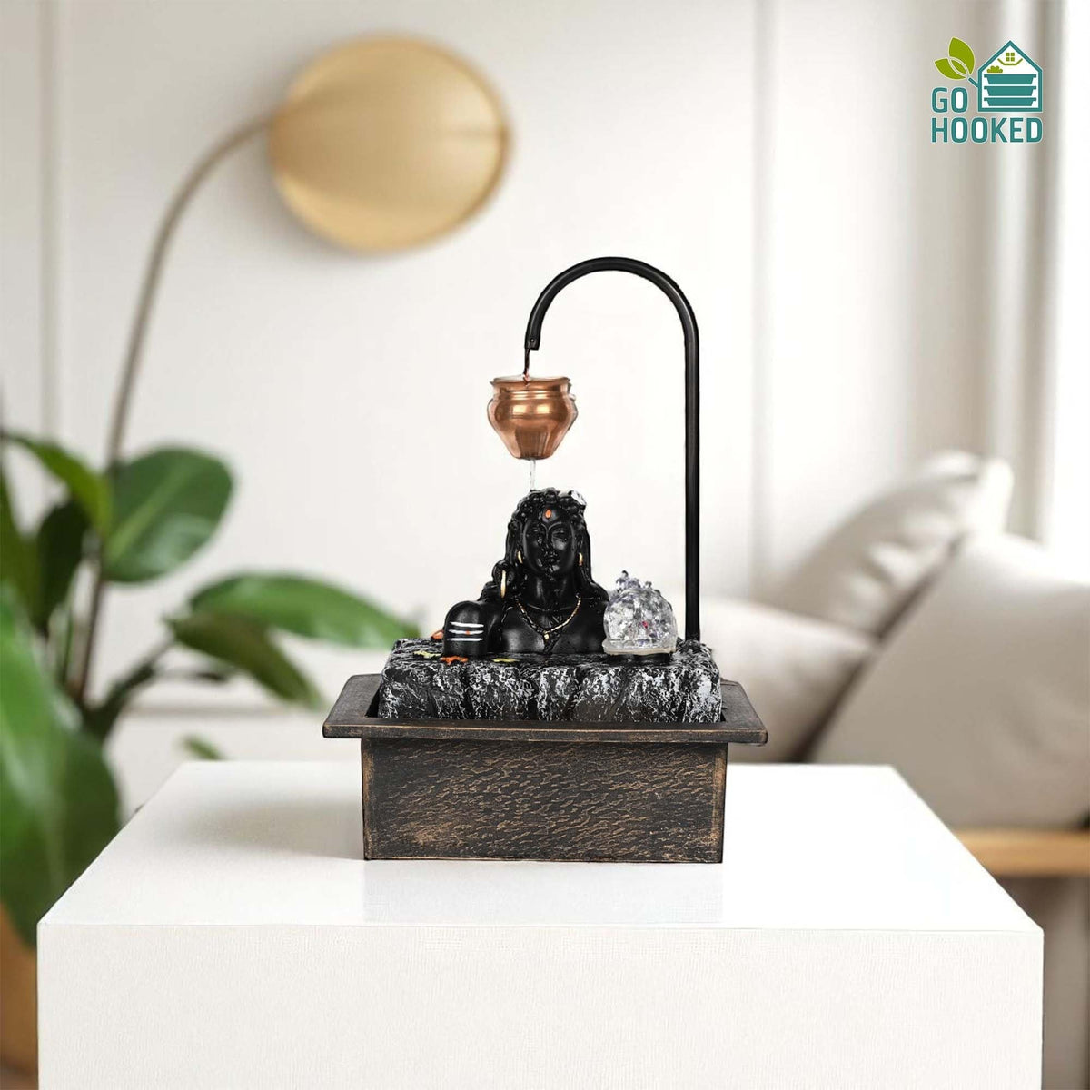 GoHooked matte black polyresin table fountain with Lord Shiva bust, copper kalash, and LED crystal ball. Features adjustable water flow.