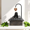 GoHooked matte black polyresin table-top water fountain with Lord Shiva bust, copper kalash, and LED crystal ball.