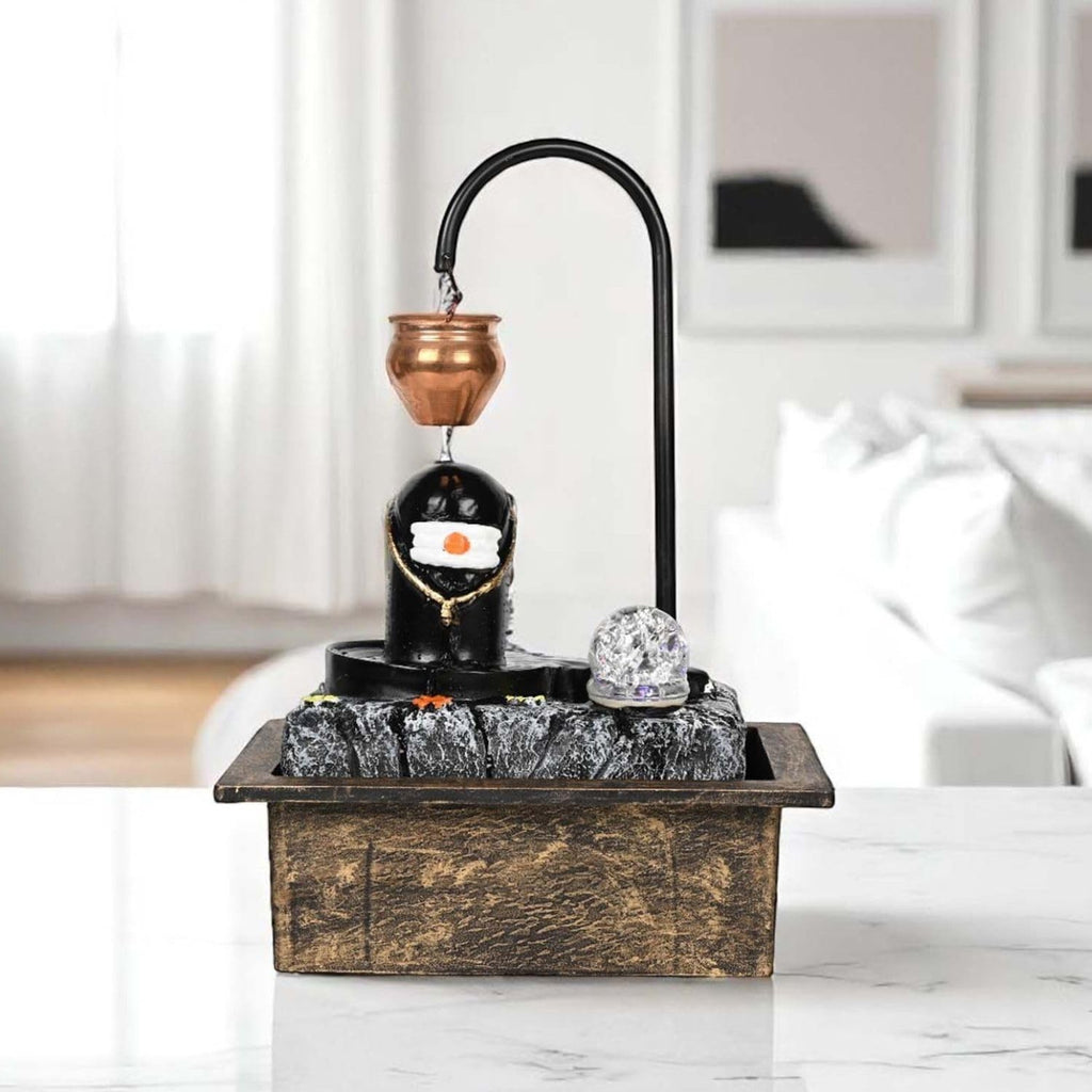 GoHooked Shivling fountain with copper kalash drip, LED crystal ball, and adjustable water flow. Matte black polyresin.