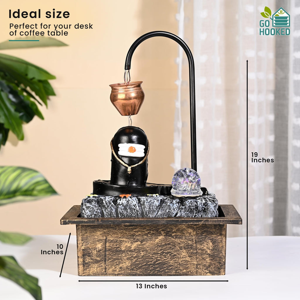 GoHooked Shivling fountain with copper kalash drip, LED crystal ball, and adjustable water flow. Matte black polyresin.