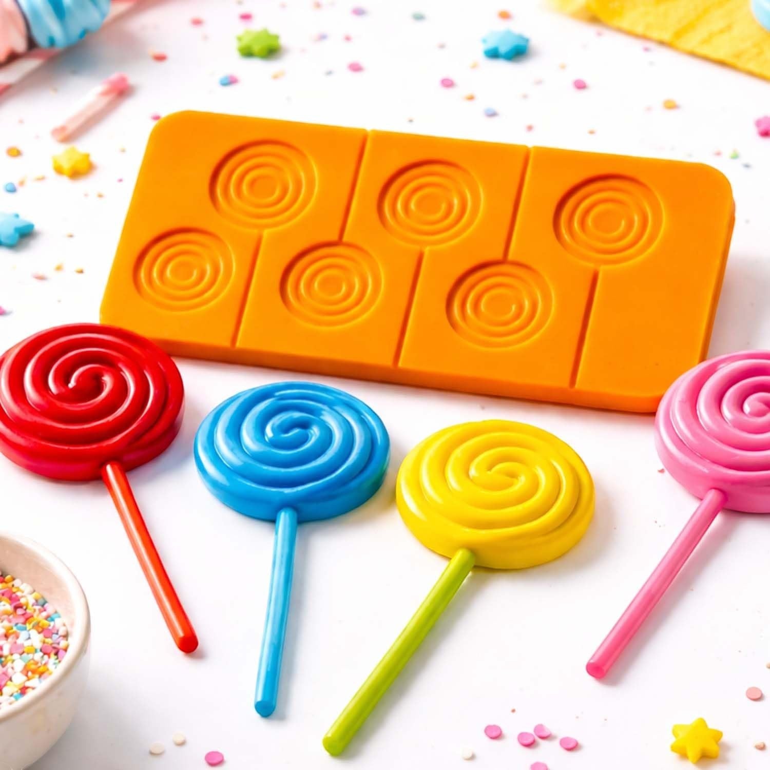 GoHooked silicone lollipop mold with spiral cavities and colorful finished candy lollipops on a table.