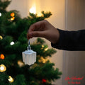 Go Hooked silver gift box Christmas ornament with glitter details, hanging on a tree.