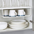 GoHooked silver powder-coated iron under-shelf basket organiser holding mugs and plates in a cabinet.