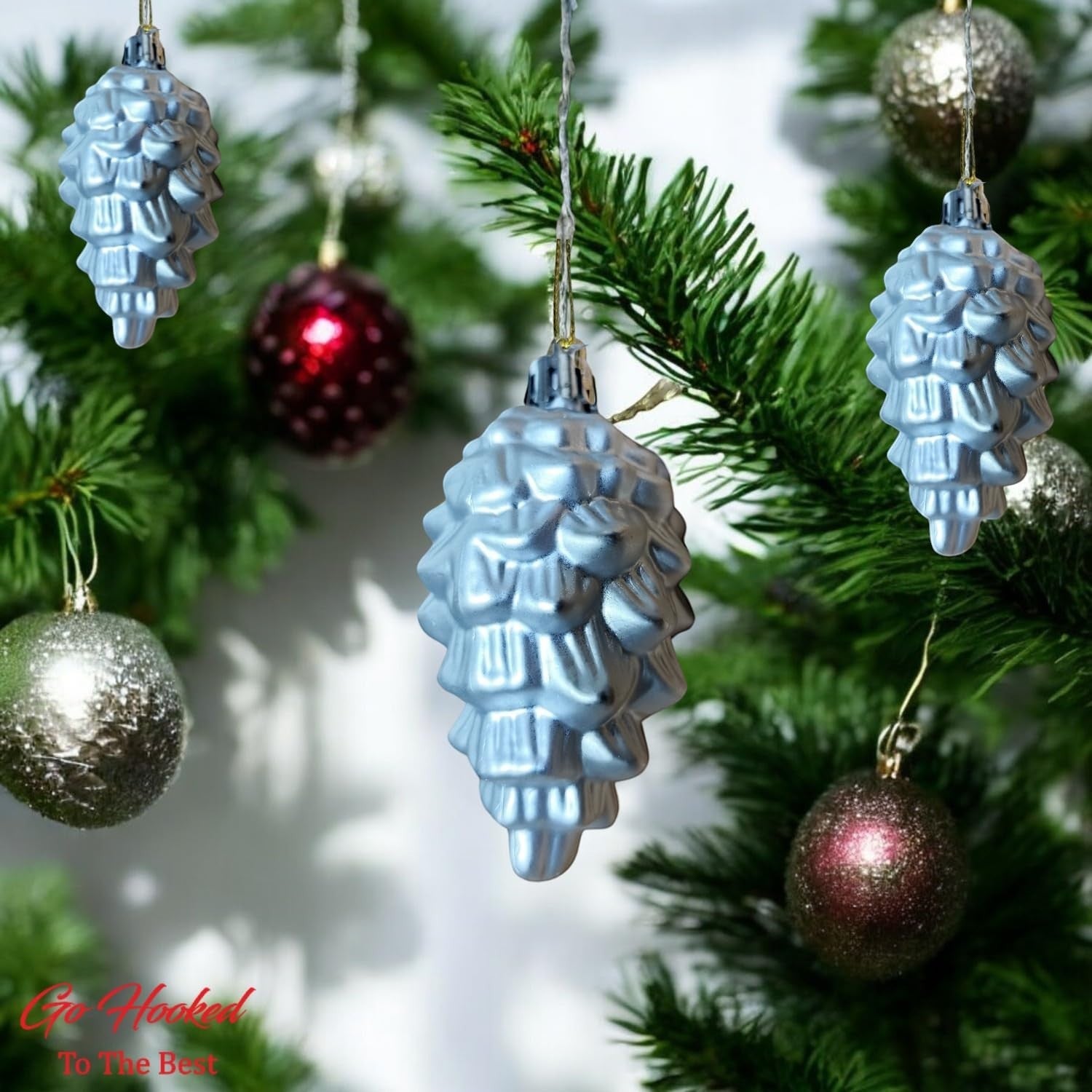 Go Hooked silver pine cone Christmas ornaments with glitter accents, 4-inch, pack of 6. Festive decor for trees, walls, and doors.