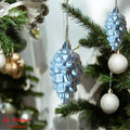 Go Hooked silver pine cone Christmas ornaments with glitter accents, hanging on a tree.