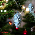 Go Hooked silver pine cone Christmas ornaments, 4-inch, pack of 6. Festive, glittery, and reusable.