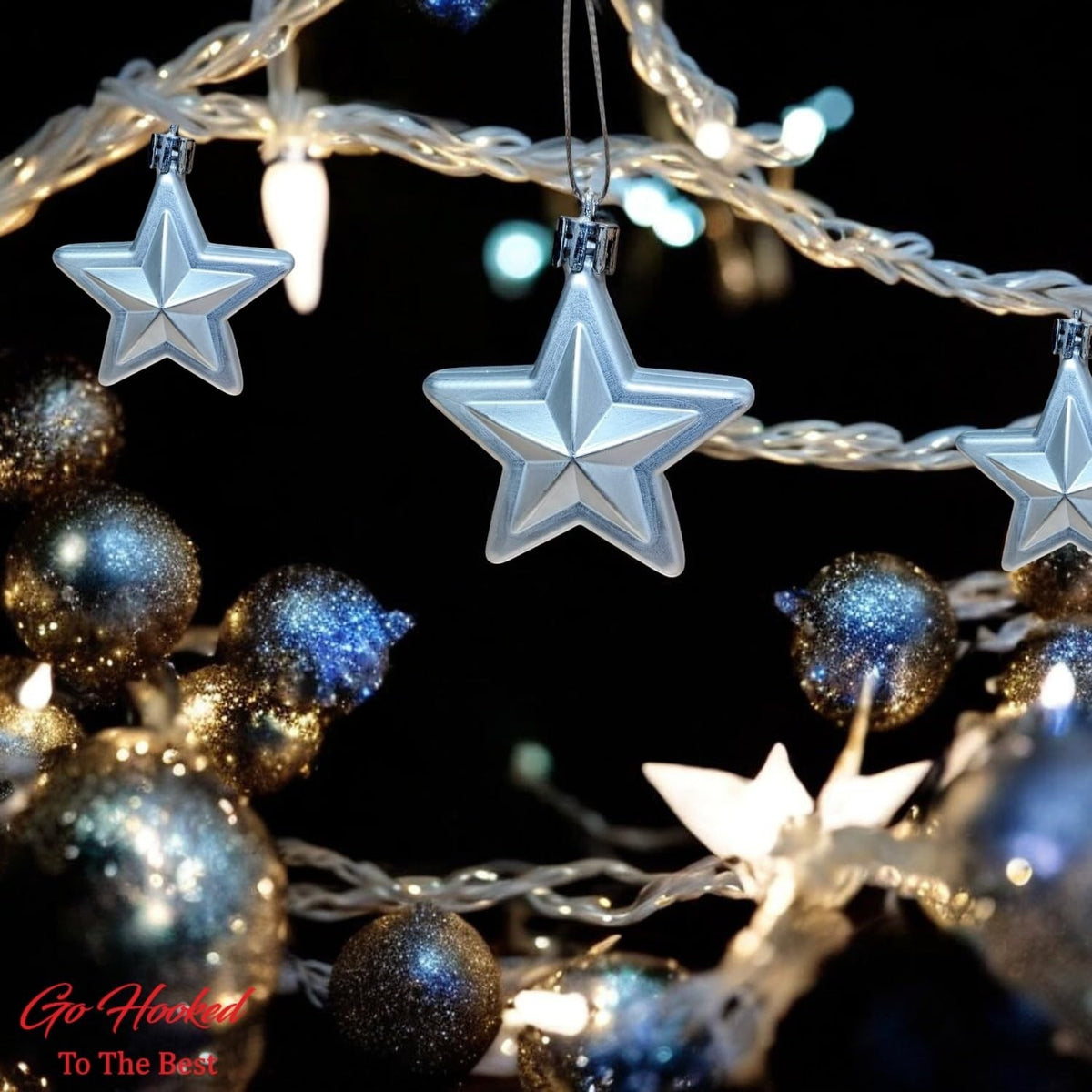 GoHooked silver glitter star Christmas ornaments hanging with festive lights and baubles.