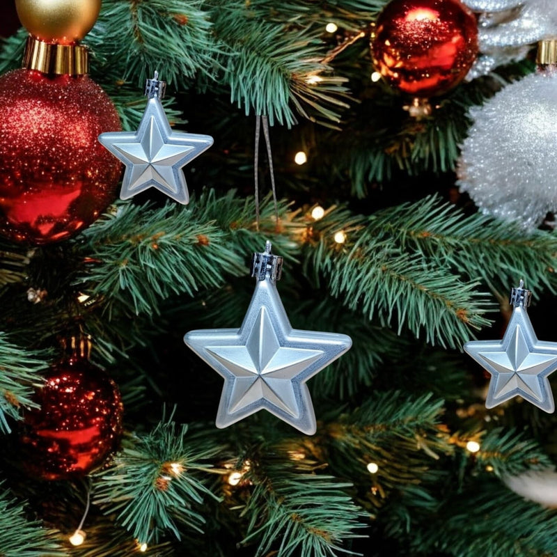 GoHooked silver star Christmas ornaments with glitter accents hanging on a decorated tree with red and gold baubles.