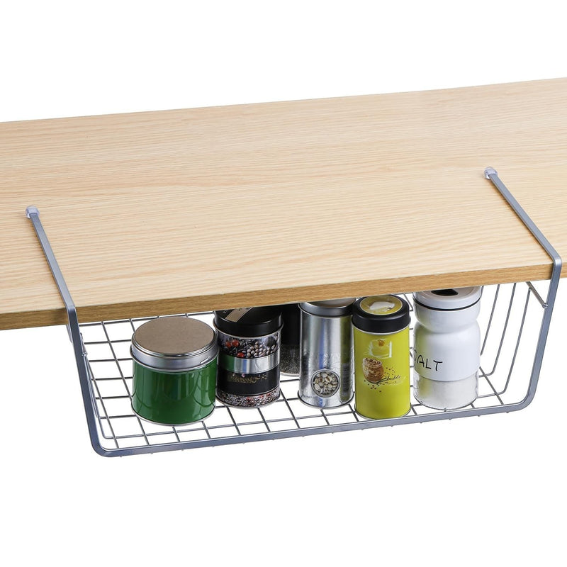 Go Hooked silver wire undershelf storage basket holding spice tins and a salt container under a wooden surface.