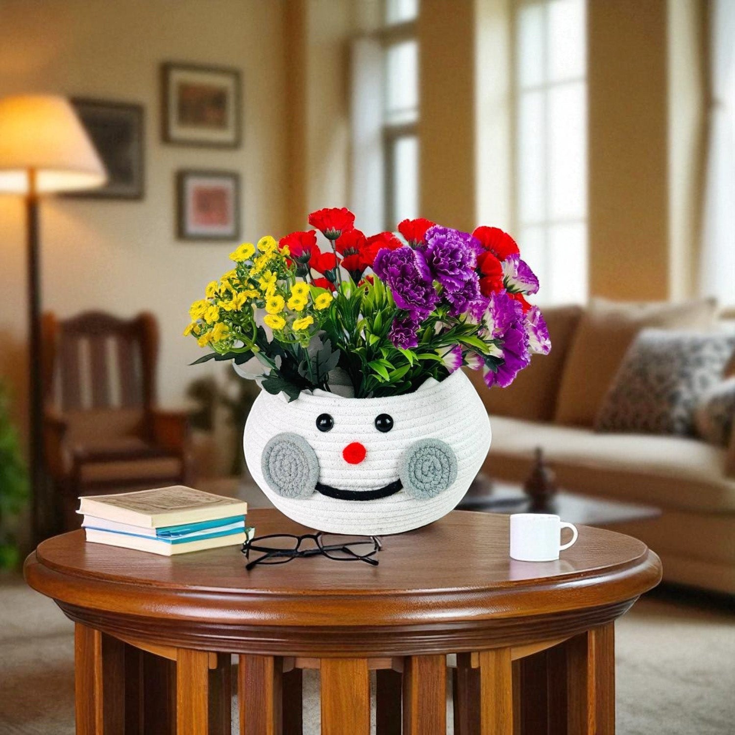 GoHooked white cotton rope snowman storage basket filled with colorful flowers on a wooden table in a living room