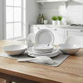Go Hooked 16-piece speckled white melamine dinnerware set with plates, bowls, and serving spoon.