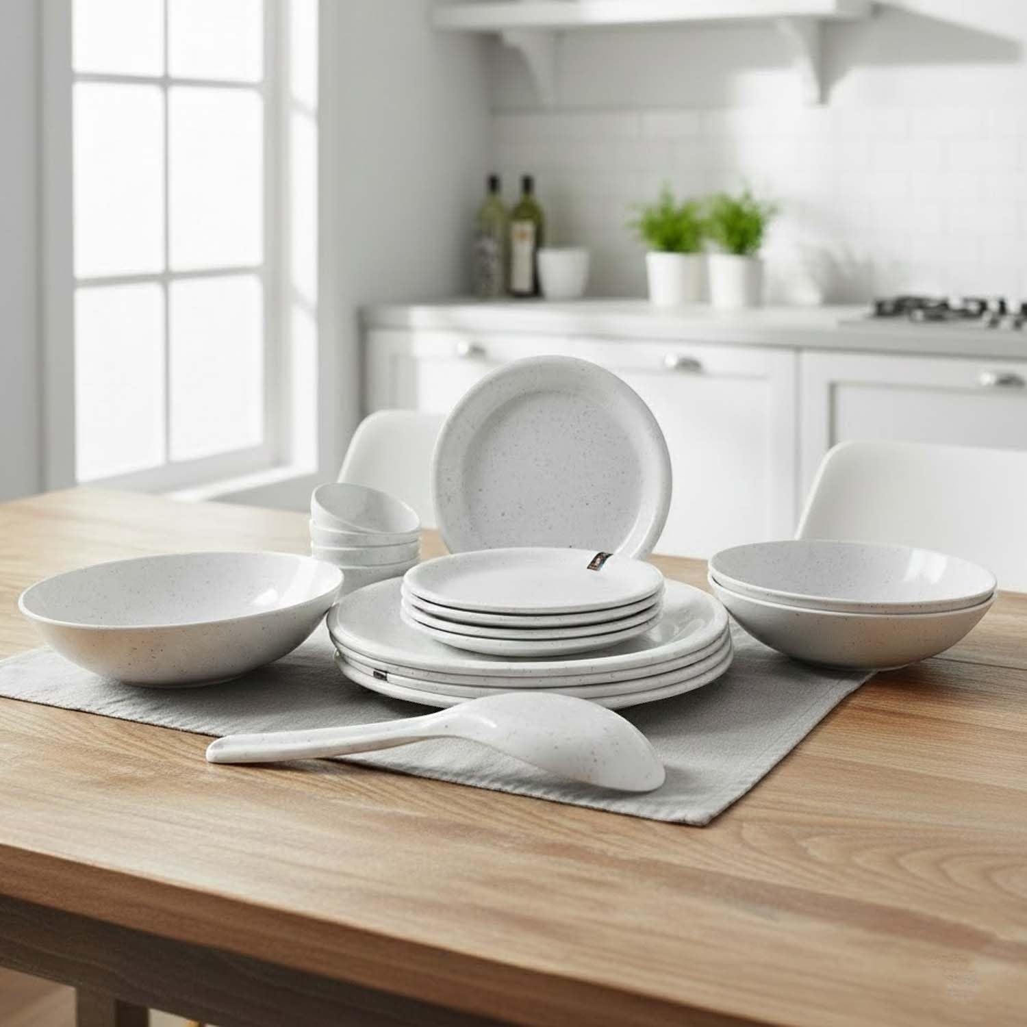 Go Hooked 16-piece speckled white melamine dinnerware set with plates, bowls, and serving spoon.