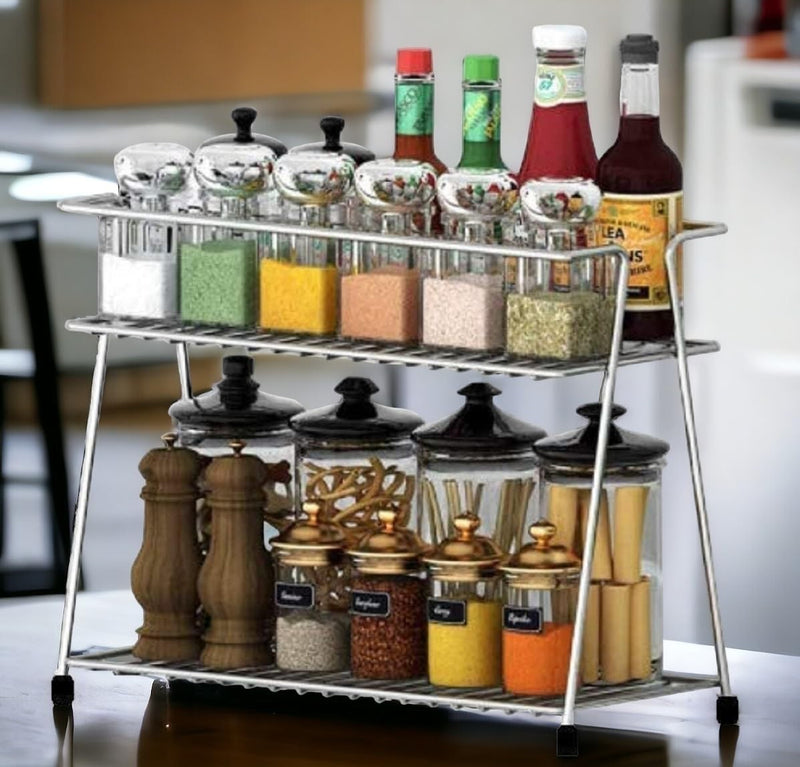 GoHooked stainless steel 2-tier shelf basket organizer filled with spices, condiments, and bottles.