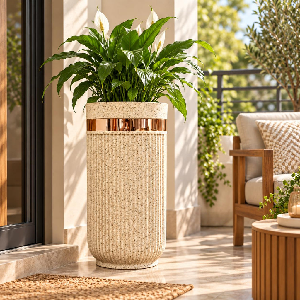 GoHooked 24-inch tall round sandstone planter with vertical ribbed texture and a metallic gold accent band on a patio.