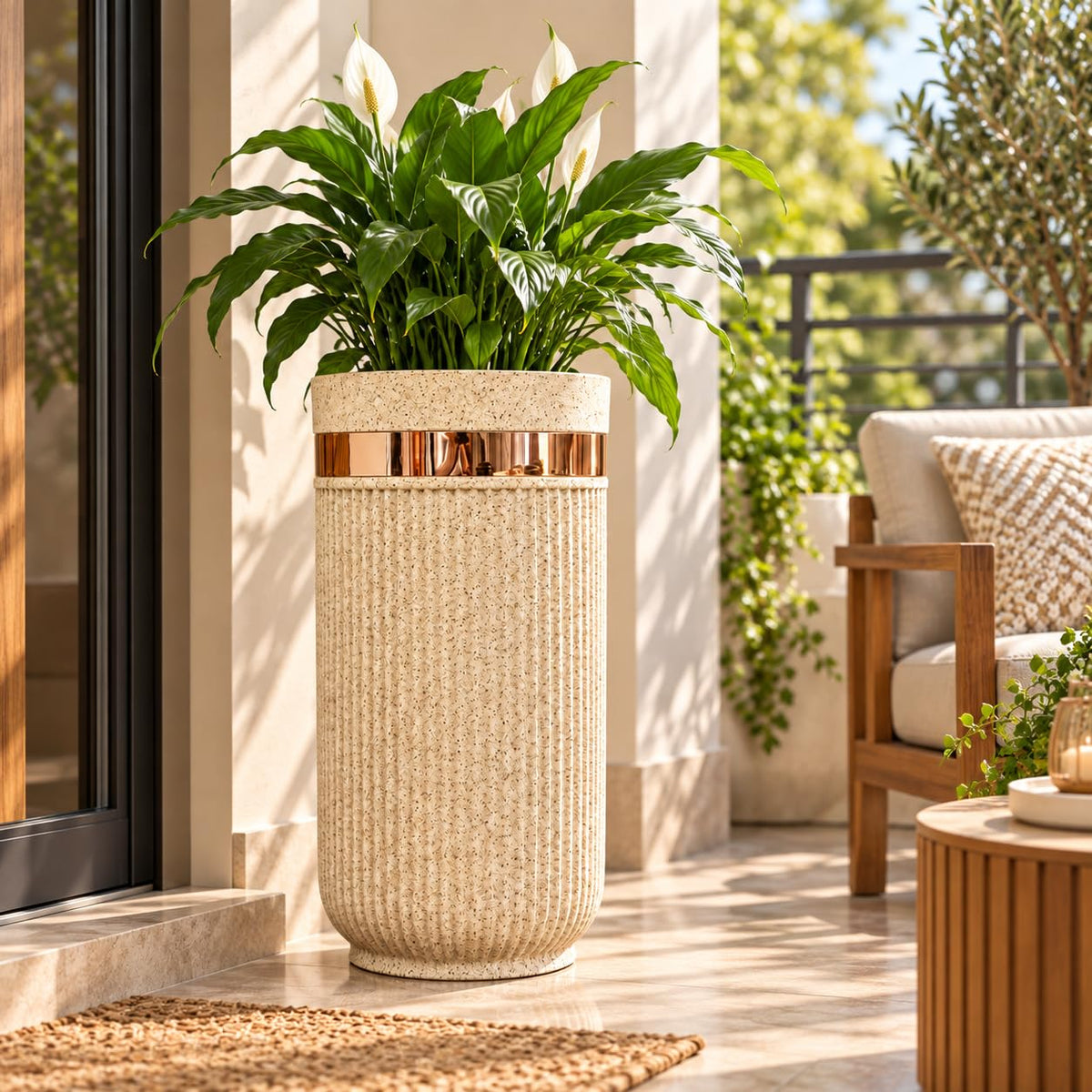 GoHooked 24-inch tall round sandstone planter with vertical ribbed texture and a metallic gold accent band on a patio.