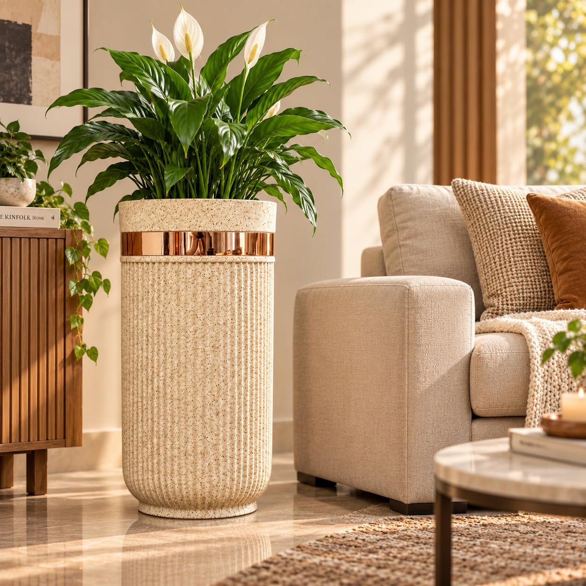 GoHooked 24-inch tall brown sandstone planter with vertical ribbed texture and a metallic gold accent band in a living room
