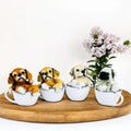 GoHooked set of 4 resin teacup dog figurines: brown, golden, cream, and pug puppies. Realistic hand-painted detail.