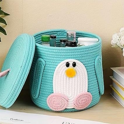 GoHooked teal cotton rope storage basket with a cute penguin design and removable lid for nursery organization.