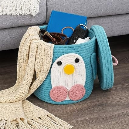 GoHooked teal cotton rope storage basket with a cute penguin face design, lid, and soft woven texture for nursery.