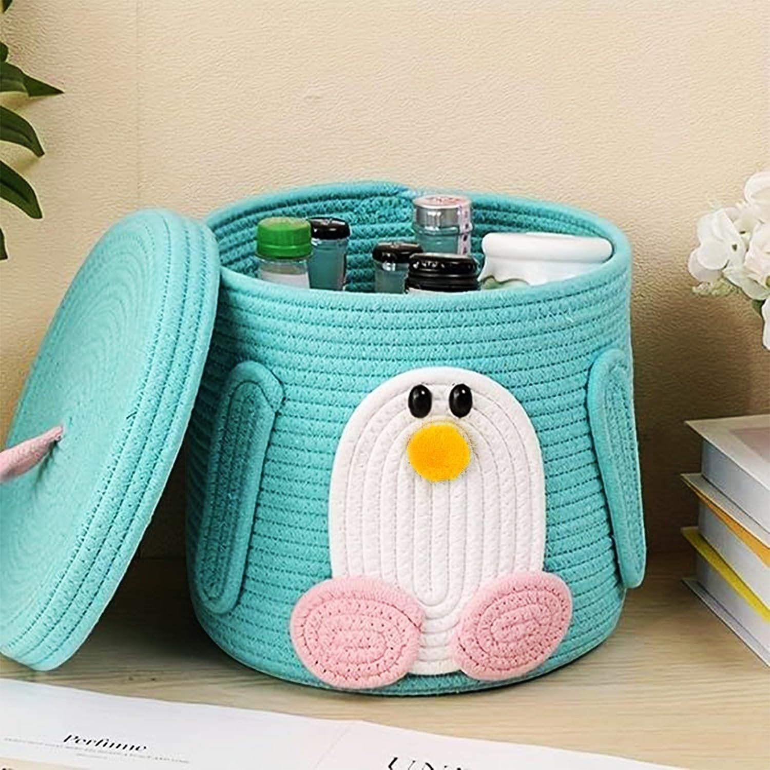 GoHooked teal cotton rope storage basket with lid, featuring a white penguin face with pink feet and yellow beak. Ideal for nursery or kids' room.