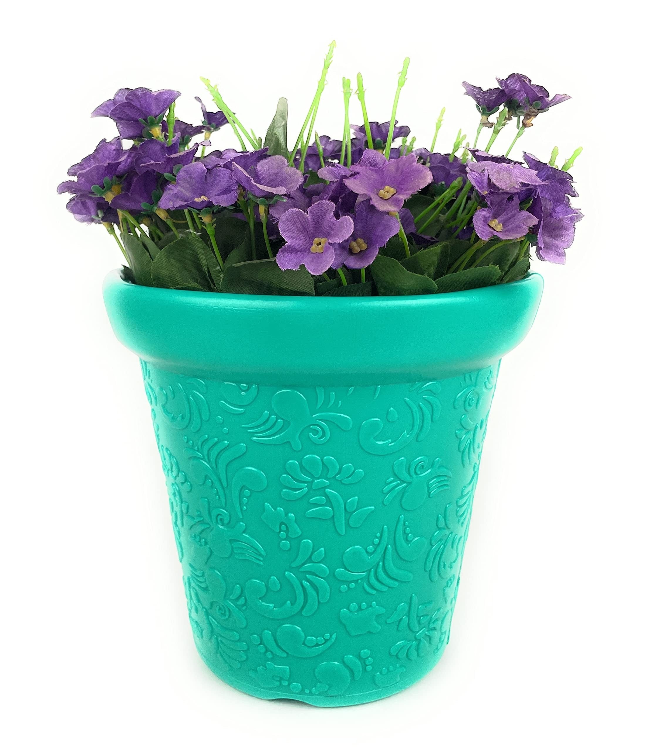 Go Hooked teal plastic planter pot with embossed floral pattern, filled with purple flowers.