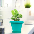 GoHooked teal plastic planter pot with saucer, modern design, suitable for indoor/outdoor plants.