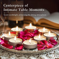 GoHooked unscented tealight candles in silver holders, with pink rose petals on a decorative tray. Pack of 50.