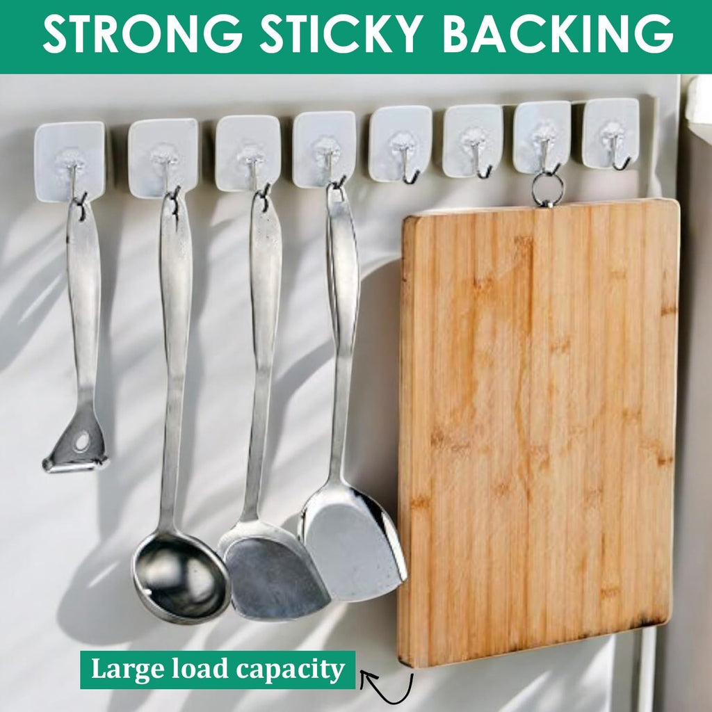 GoHooked transparent adhesive hooks holding kitchen utensils and a wooden cutting board. Heavy-duty, no-drilling.
