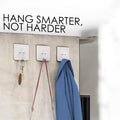 GoHooked transparent flower-shaped adhesive hooks holding keys, a bag, and a blue jacket. Heavy-duty, no-drill, waterproof.