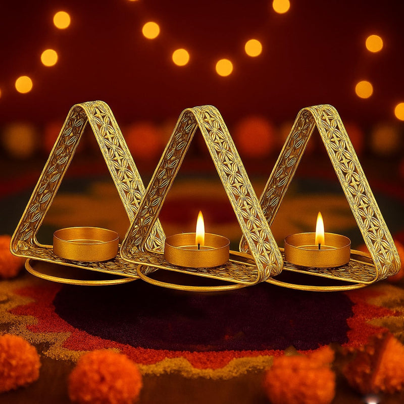 GoHooked Set of 3 matte gold metal triangular tealight holders with floral cutwork. Festive decor.