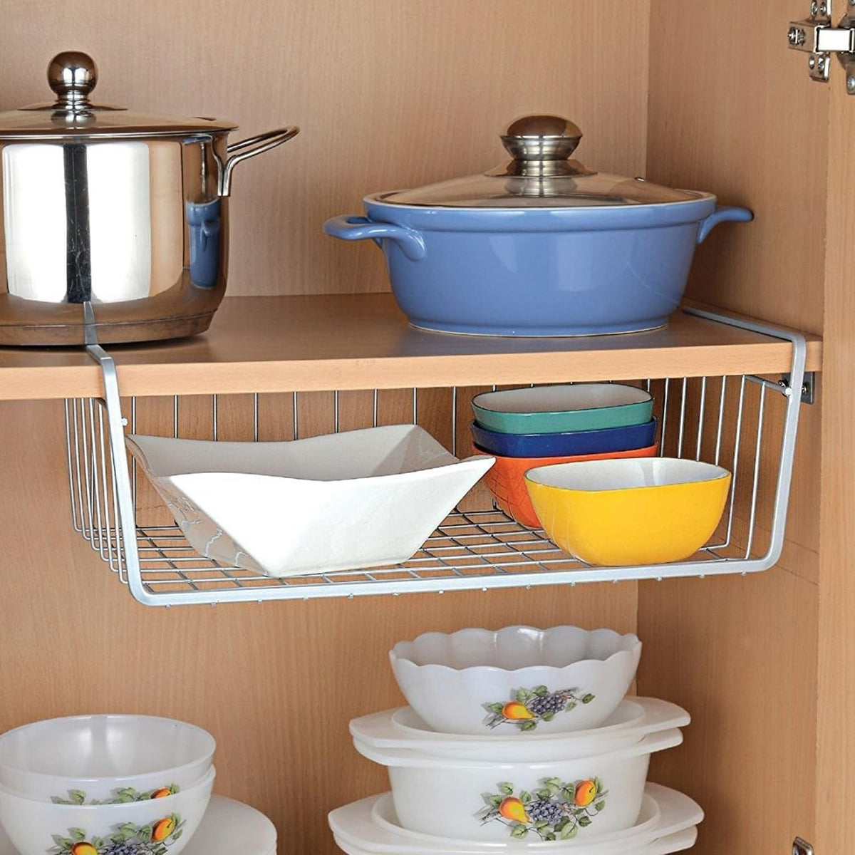 Go Hooked 16" silver wire undershelf storage basket with white bowl and colorful bowls inside.
