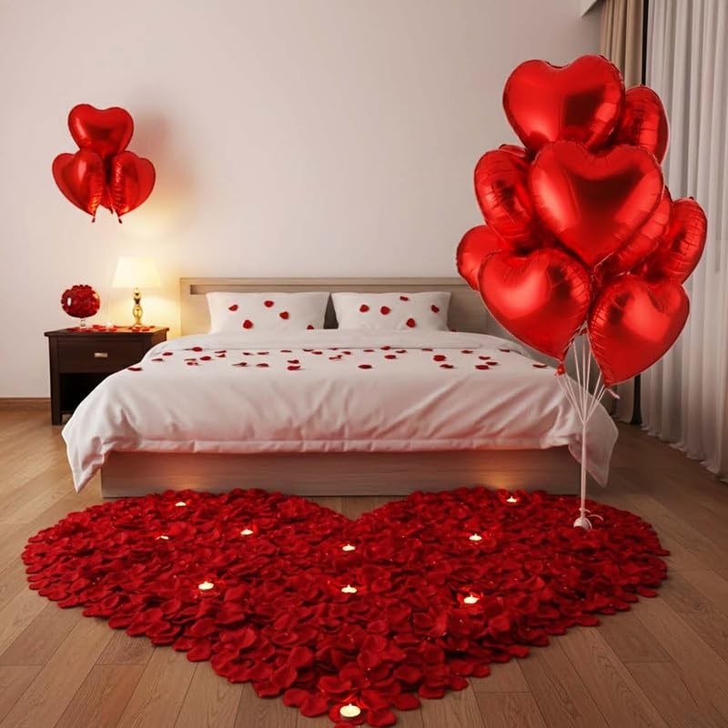 GoHooked Valentine's Day decor set with red heart balloons and rose petals on a bed and floor.