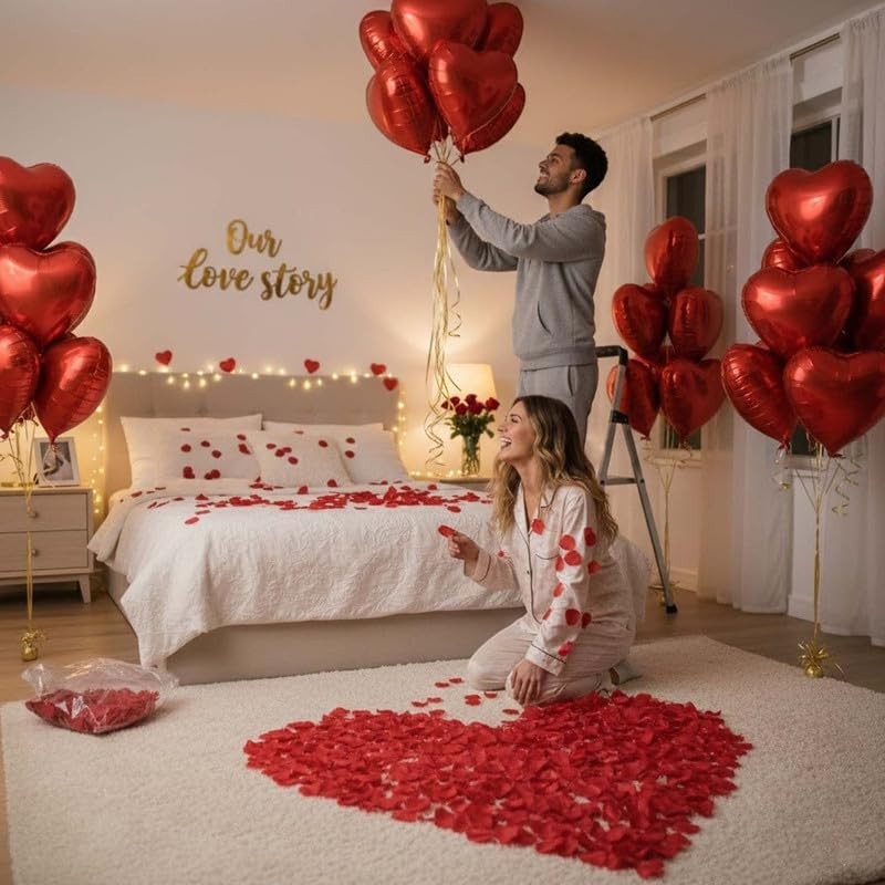 GoHooked Valentine's Day decor set with red heart balloons and artificial rose petals scattered on bed and floor.