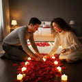 Go Hooked Valentine's Day gift set with a couple arranging LED candles and red rose petals for a romantic ambiance.