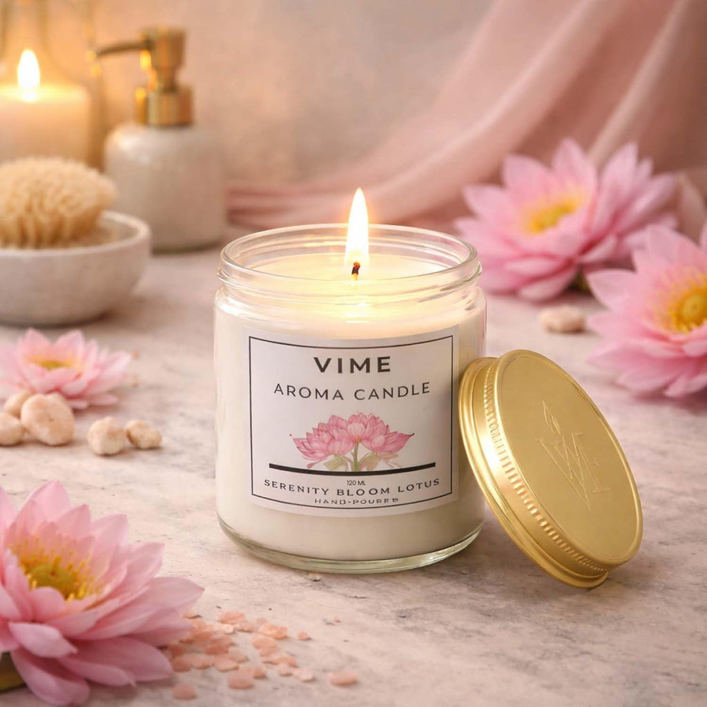 ViMe Serenity Bloom Lotus aroma candle in a glass jar with a gold lid, burning with a soft flame.