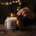 GoHooked ViMe Coffee Lover scented candle in a glass jar, being lit with a match. White wax, gold lid.