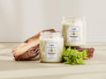 GoHooked ViMe Fruit Fusion aroma candle in a white glass jar with a wooden accent and green leaves.