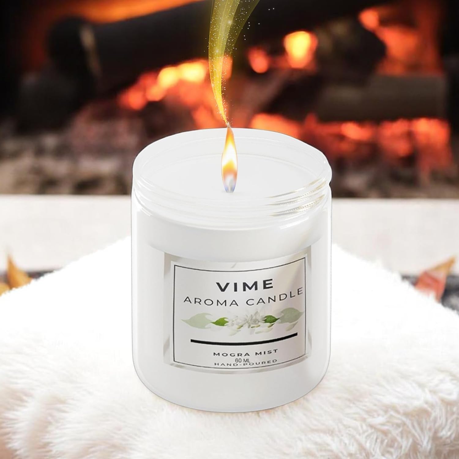 GoHooked ViMe Mogra Mist aroma candle in a white jar, burning with a warm flame, set against a cozy fireplace.