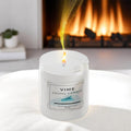 GoHooked Vime Ocean Breeze scented candle in a white jar, burning with a gentle flame, 120ml.