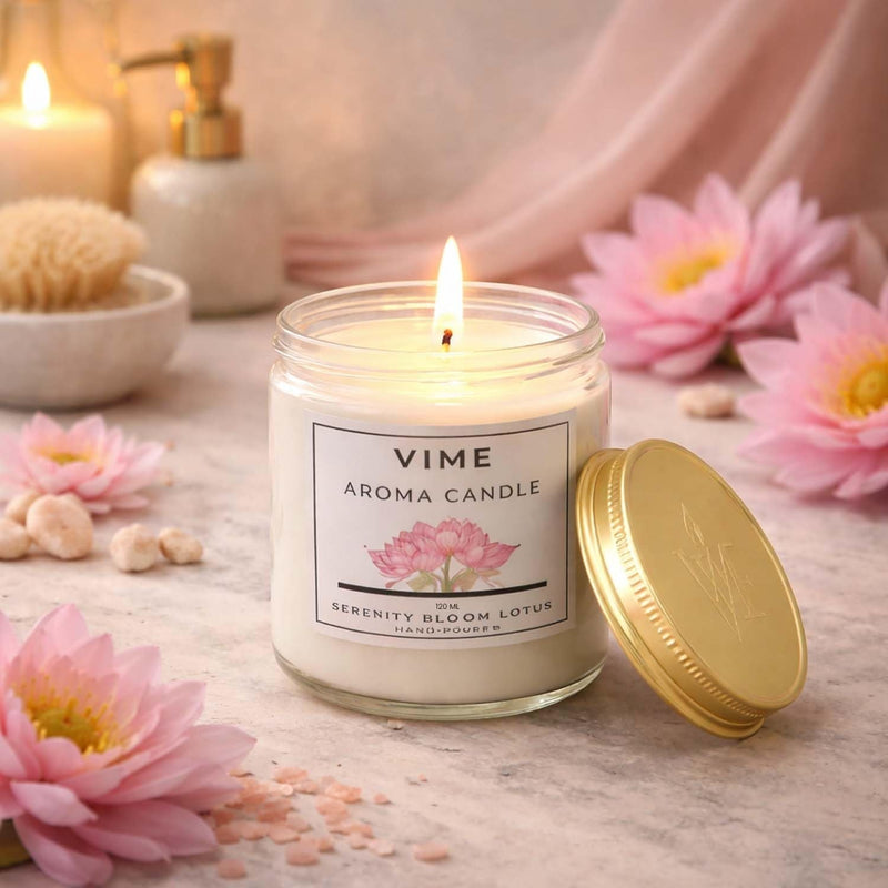 GoHooked ViMe Serenity Bloom Lotus aroma candle in a glass jar with a gold lid, burning with a soft flame.
