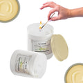 GoHooked ViMe Vanilla Mousse aroma candle in a white jar with a gold lid, being lit by a match.